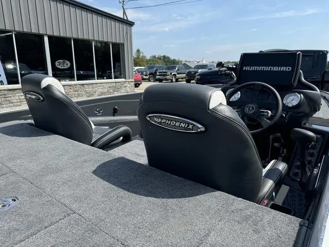 Slide: The Image of 2025 Phoenix 721 ZXL boat interior with black seats and Humminbird electronics. - 5