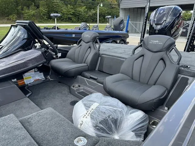 Slide: The Image of 2025 Skeeter ZXR21 boat interior with dual seats and modern dashboard. - 16