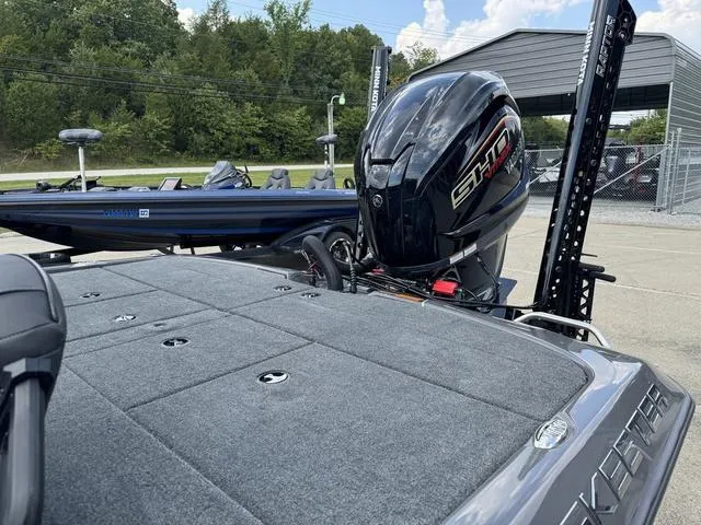 Slide: The Image of 2025 Skeeter ZXR21 boat with powerful outboard motor, parked outdoors. - 17