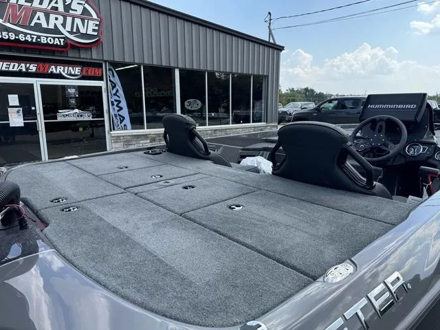 Slide: The Image of 2025 Skeeter ZXR21 boat at dealership, featuring spacious deck and modern seating. - 3