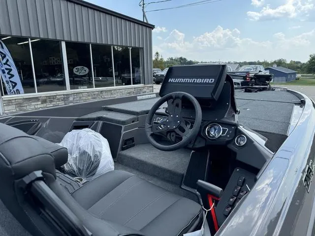 Slide: The Image of 2025 Skeeter ZXR21 boat interior with Humminbird electronics, parked outside dealership. - 4