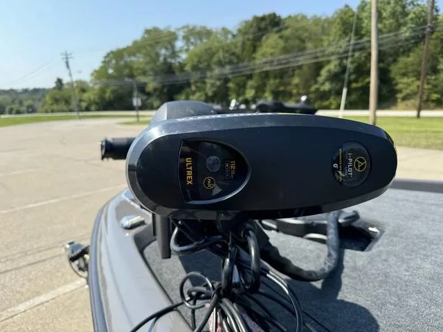 Slide: The Image of Close-up of a 2025 Skeeter ZXR 20 boat's trolling motor in a parking lot. - 11