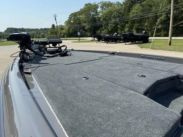 Slide: The Image of 2025 Skeeter ZXR 20 boat deck with advanced fishing equipment, parked outdoors. - 15