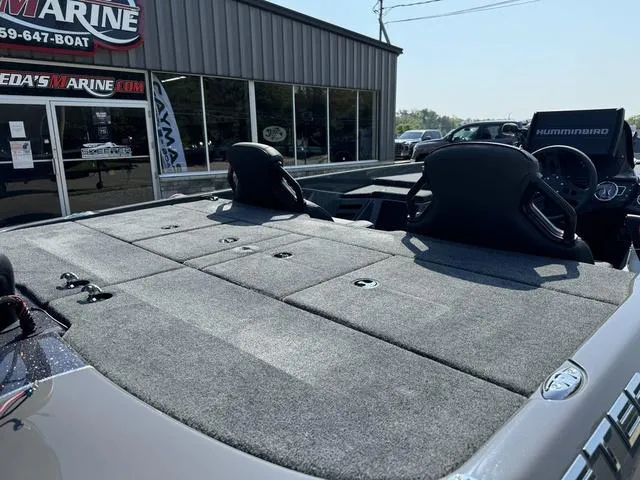 Slide: The Image of 2025 Skeeter ZXR 20 boat with spacious deck and seating at a marine dealership. - 4