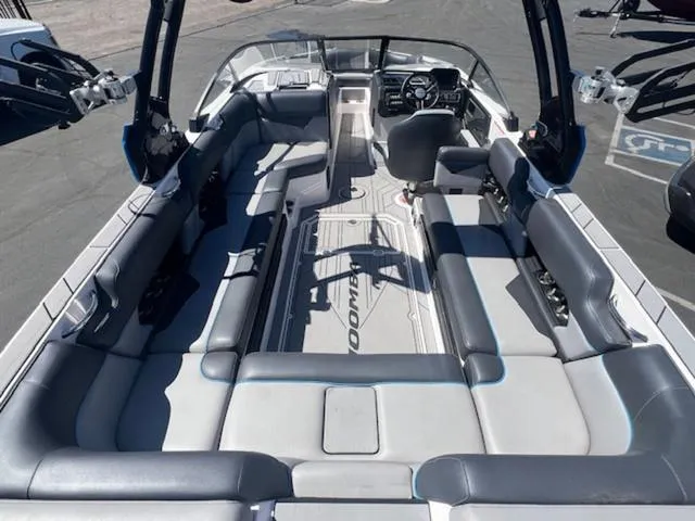 Slide: The Image of 2021 Moomba Makai boat interior with spacious seating and modern dashboard. - 10