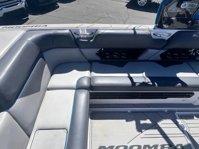 Slide: The Image of 2021 Moomba Makai boat interior with gray seating and cup holders. - 13