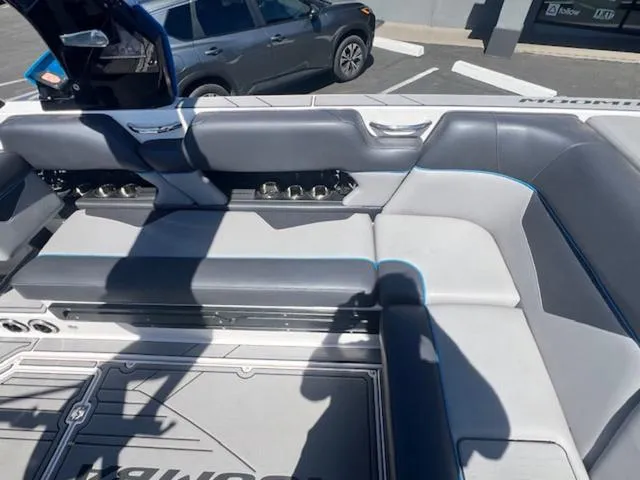 Slide: The Image of 2021 Moomba Makai boat interior with gray seating and cup holders. - 15