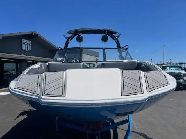 Slide: The Image of 2021 Moomba Makai boat with sleek design, parked outdoors under clear blue sky. - 3