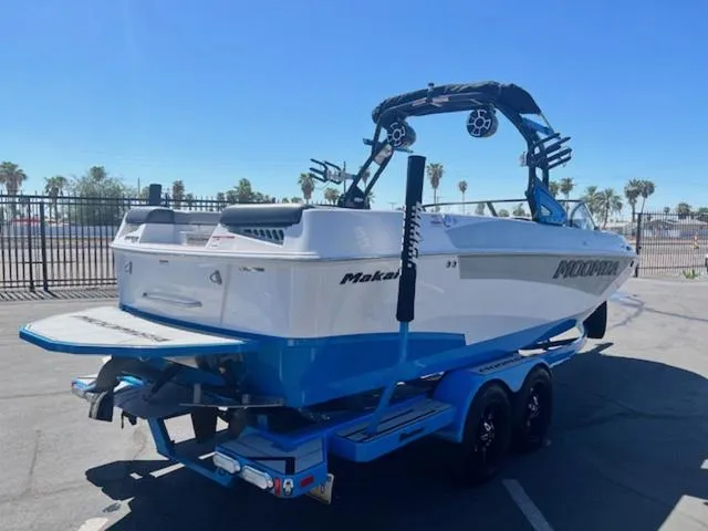Slide: The Image of 2021 Moomba Makai boat on trailer, parked outdoors under clear sky. - 6