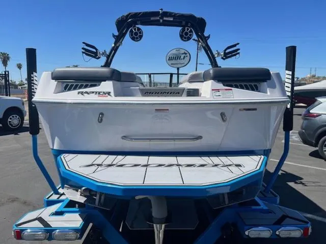 Slide: The Image of 2021 Moomba Makai boat rear view with Raptor engine, parked outdoors. - 7