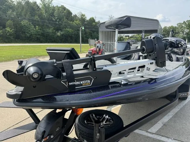 Slide: The Image of 2025 Skeeter ZXR20 boat with Minn Kota Ultrex motor in a parking lot. - 13