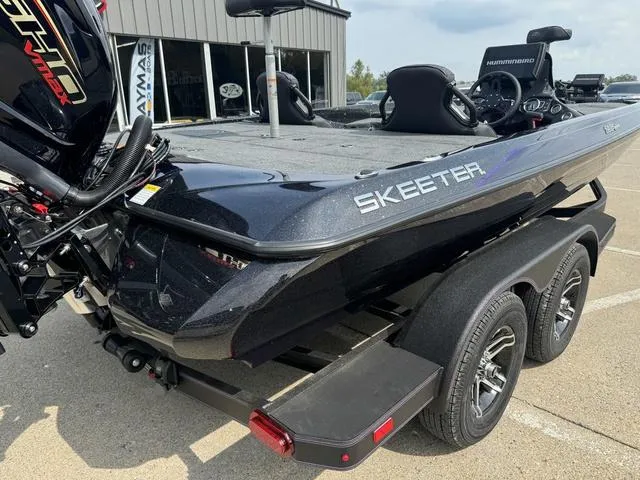 Slide: The Image of 2025 Skeeter ZXR20 boat on trailer, black finish, parked outdoors. - 4