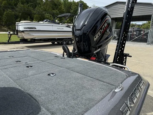Slide: The Image of 2025 Skeeter ZXR20 boat with powerful outboard motor, parked near a marina. - 17
