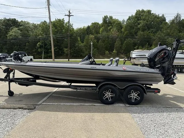 Slide: The Image of 2025 Skeeter ZXR20 boat on trailer, parked outdoors. - 19