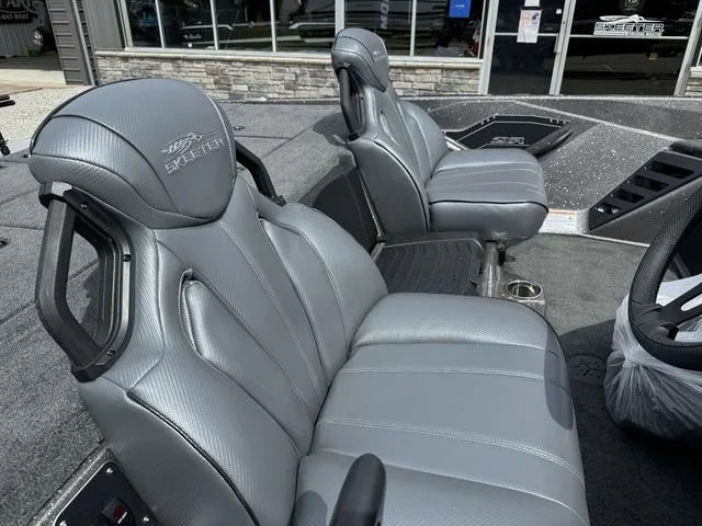 Slide: The Image of 2025 Skeeter ZXR20 boat interior with gray leather seats and modern design. - 7