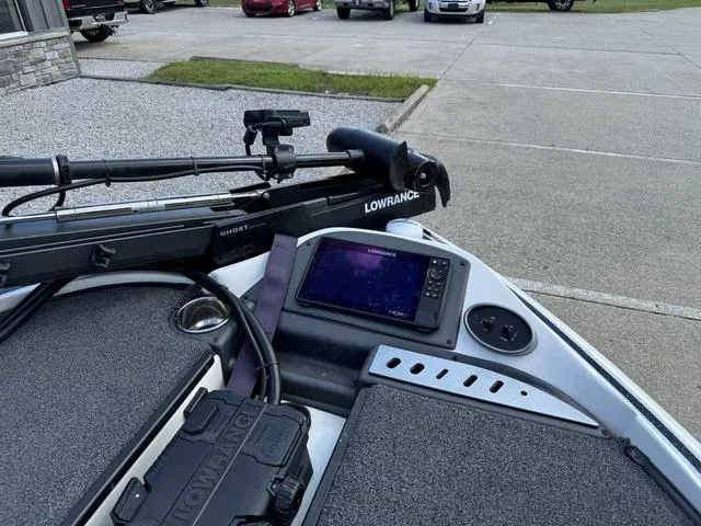 Slide: The Image of 2023 Triton 19 TrX Patriot boat with Lowrance electronics and trolling motor in parking lot. - 10