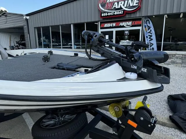Slide: The Image of 2023 Triton 19 TrX Patriot boat displayed at a marine dealership. - 11