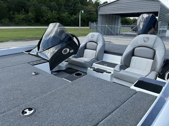 Slide: The Image of 2023 Triton 19 TrX Patriot boat interior with dual seats and console. - 14
