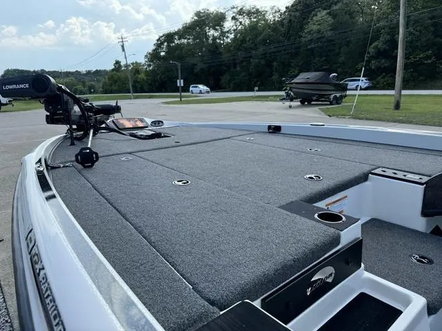 Slide: The Image of 2023 Triton 19 TrX Patriot boat with spacious deck and advanced navigation equipment. - 16