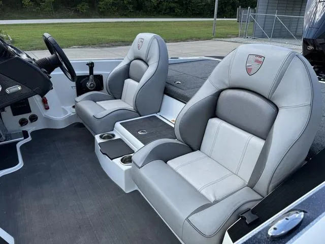 Slide: The Image of 2023 Triton 19 TrX Patriot boat interior with gray and white seats. - 17
