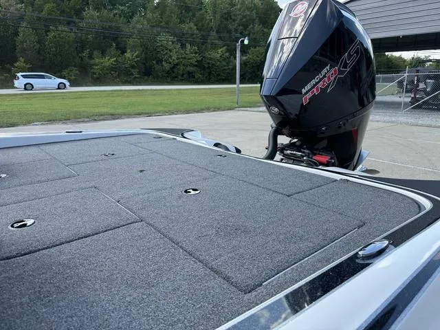 Slide: The Image of 2023 Triton 19 TrX Patriot boat with Mercury engine, parked outdoors. - 18