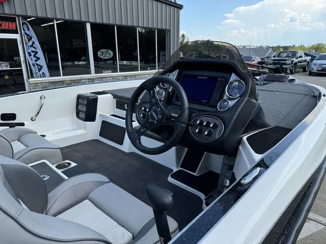 Slide: The Image of 2023 Triton 19 TrX Patriot boat interior with steering wheel and dashboard controls. - 5
