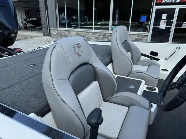 Slide: The Image of 2023 Triton 19 TrX Patriot boat interior with gray and white seating. - 6