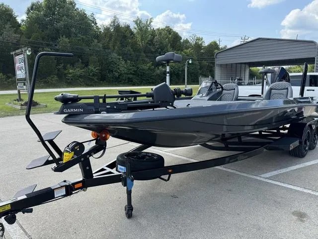 Slide: The Image of 2025 iKon VLX 21 fishing boat on trailer, featuring Garmin equipment, parked outdoors. - 13