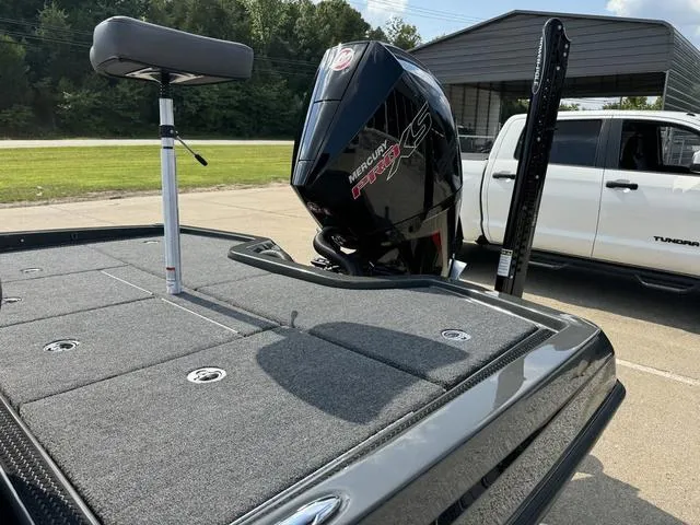 Slide: The Image of 2025 iKon VLX 21 boat with Mercury Pro XS engine, parked near a white truck. - 17