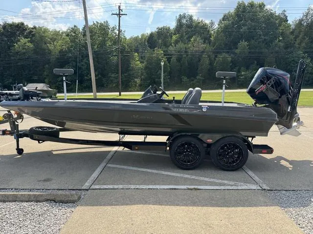 Slide: The Image of 2025 iKon VLX 21 boat on trailer, parked outdoors, side view. - 18