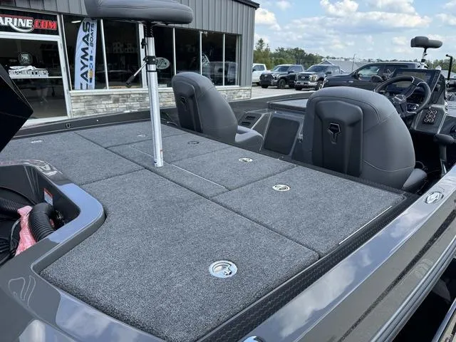 Slide: The Image of 2025 iKon VLX 21 boat interior with gray seating and storage compartments. - 4