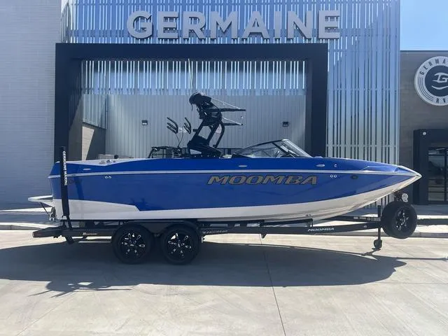 Slide: The Image of 2021 Moomba Makai boat in blue on a trailer at Germaine dealership. - 1
