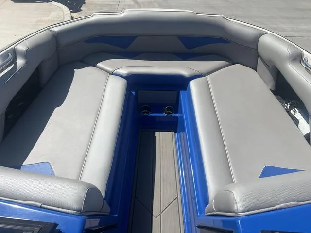 Slide: The Image of 2021 Moomba Makai boat interior with gray seating and blue accents. - 11