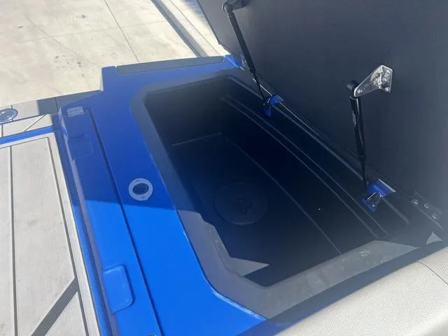 Slide: The Image of Open storage compartment in 2021 Moomba Makai boat, blue exterior. - 15