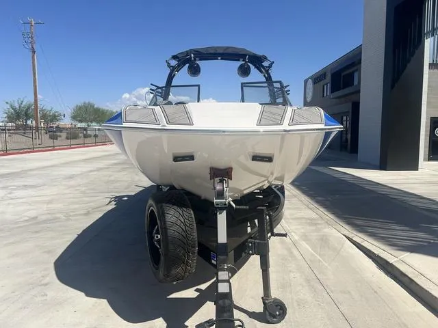 Slide: The Image of 2021 Moomba Makai boat on trailer, parked outdoors under clear blue sky. - 3