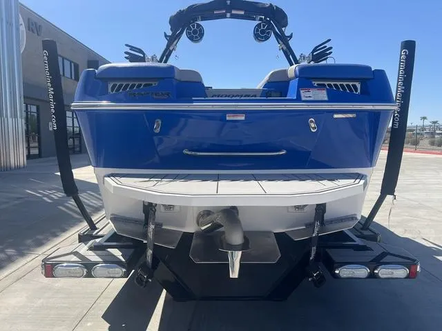 Slide: The Image of 2021 Moomba Makai boat, blue exterior, rear view, parked outdoors. - 7