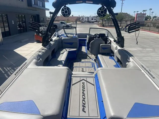 Slide: The Image of 2021 Moomba Makai boat interior with gray and blue seating, outdoor setting. - 9