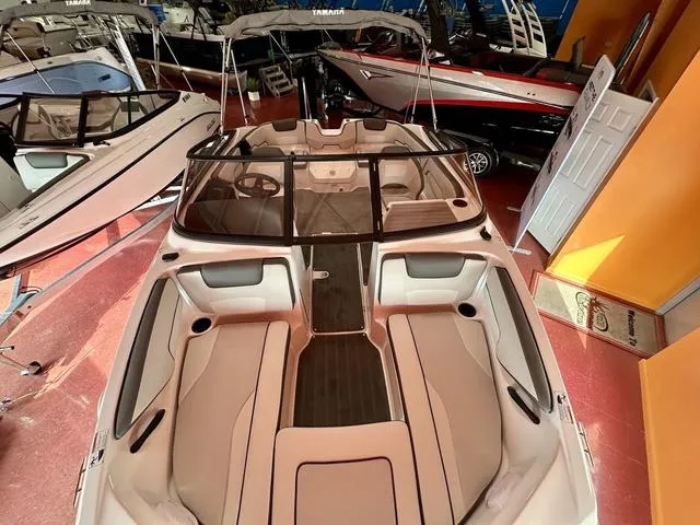Slide: The Image of 2024 Yamaha SX190 boat interior in showroom, featuring sleek seating and modern design. - 3