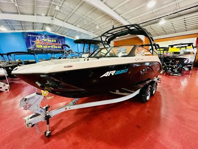 Slide: The Image of 2025 Yamaha Boats AR220 displayed in showroom on red floor. - 1