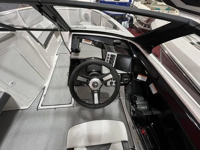 Slide: The Image of Interior view of 2025 Yamaha Boats AR220 cockpit with steering wheel and controls. - 11