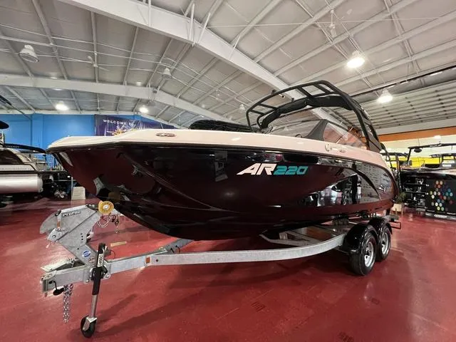 Slide: The Image of 2025 Yamaha AR220 boat on display in showroom, sleek black design. - 3