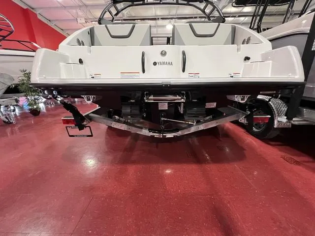 Slide: The Image of 2025 Yamaha Boats AR220 displayed in showroom, rear view. - 5