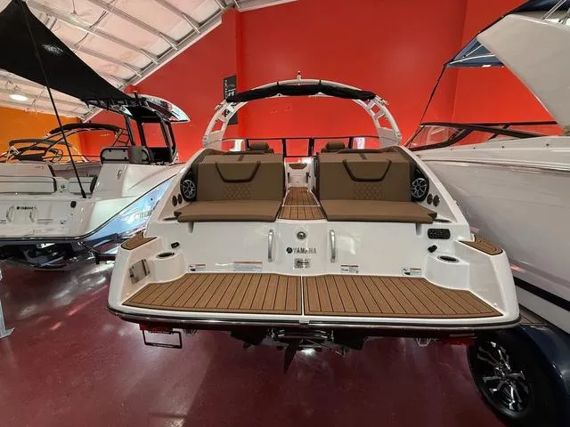 Slide: The Image of 2025 Yamaha Boats 222S in showroom, featuring sleek design and spacious seating. - 14