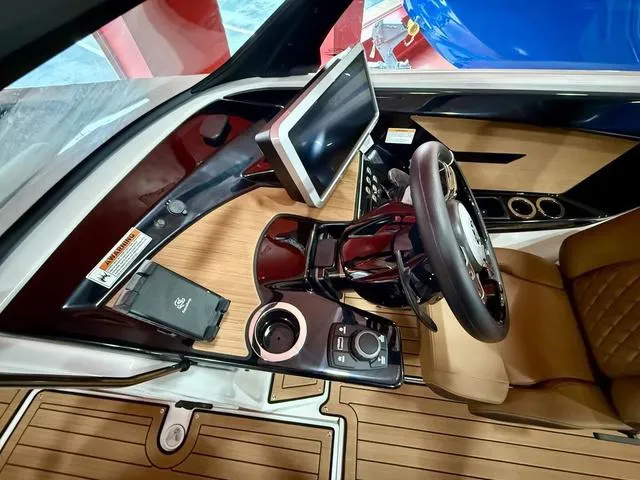 Slide: The Image of 2025 Yamaha Boats 222SD cockpit with modern steering, touchscreen, and luxurious seating. - 10