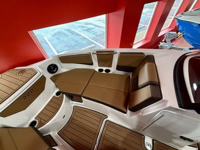 Slide: The Image of 2025 Yamaha Boats 222SD interior with brown seating and wood accents. - 13