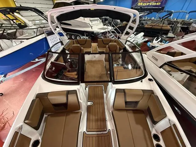 Slide: The Image of 2025 Yamaha Boats 222SD, luxury interior, spacious seating, showcased in a boat showroom. - 14