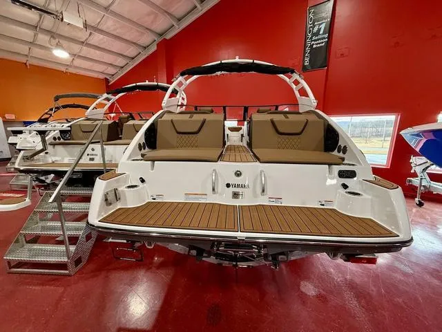 Slide: The Image of 2025 Yamaha Boats 222SD in showroom, featuring sleek design and comfortable seating. - 3