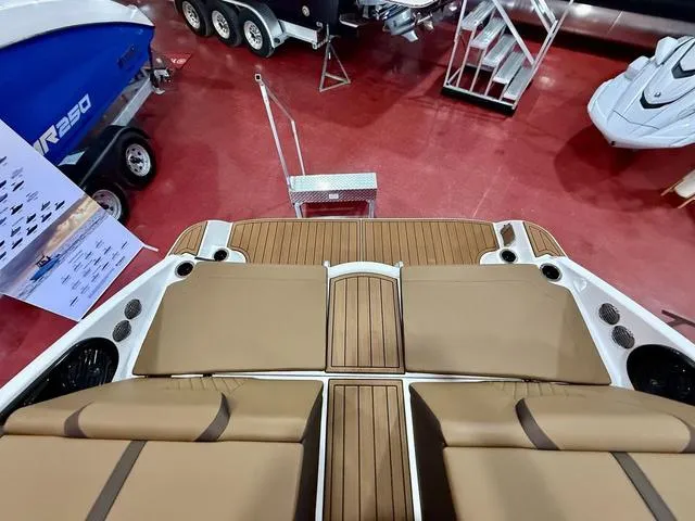 Slide: The Image of 2025 Yamaha Boats 222SD interior with tan seating and wood accents, showcased indoors. - 5