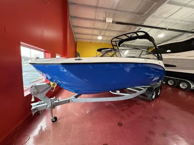 Slide: The Image of 2025 Yamaha Boats AR250 in showroom, sleek design, vibrant red and blue colors. - 3