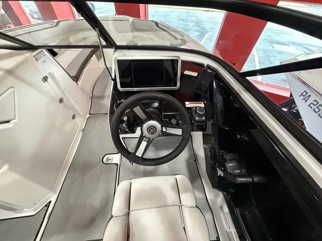 Slide: The Image of 2025 Yamaha Boats AR250 cockpit with steering wheel and modern dashboard. - 9
